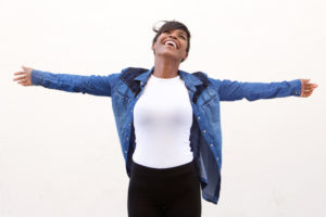 Carefree young woman with arms outstretched