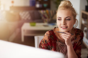 Young creative woman working at home